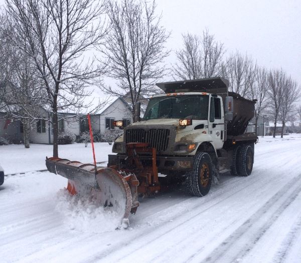 Snowplow clearing a residential street