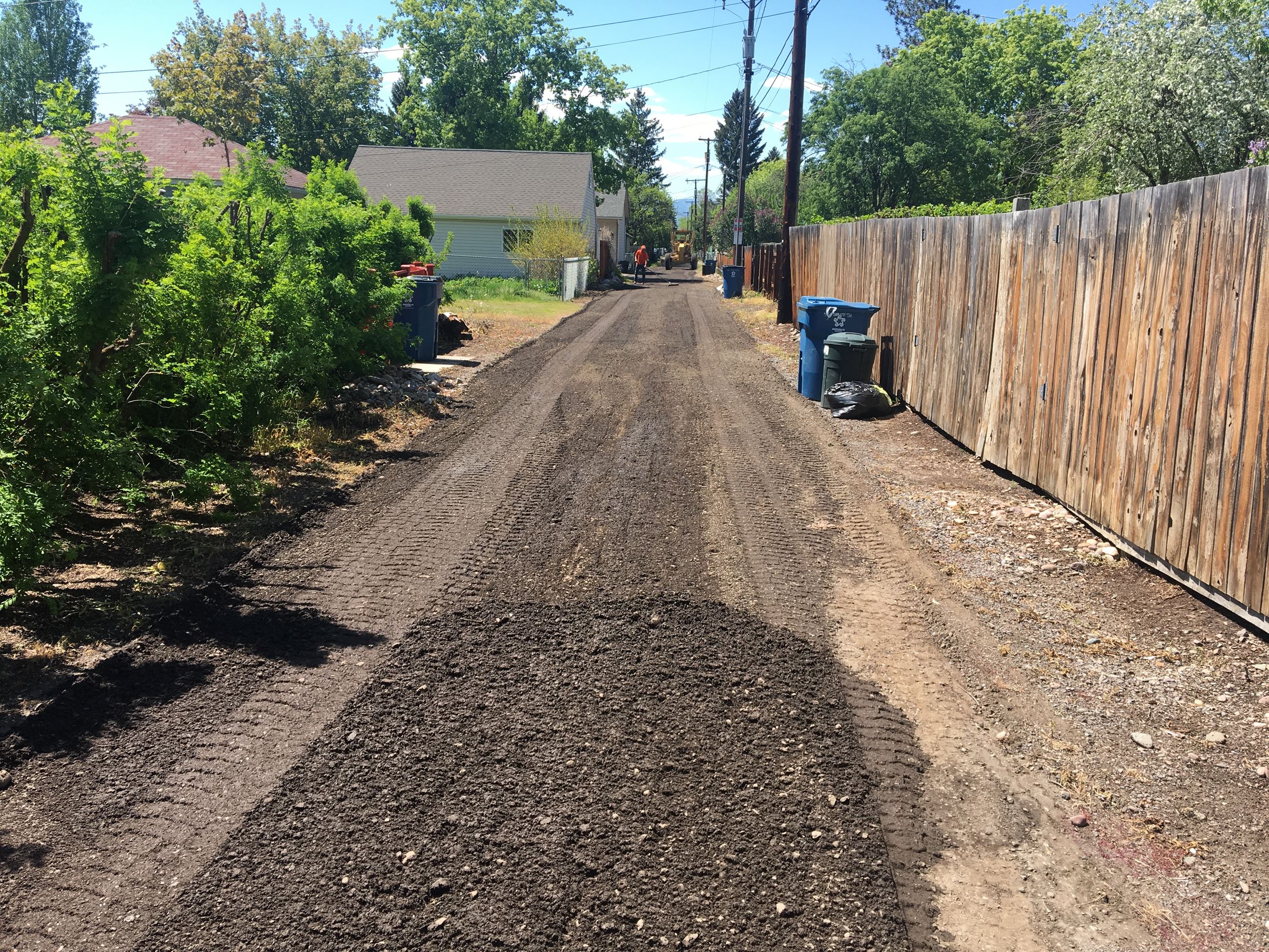 Blade smoothing out an alley in Missoula