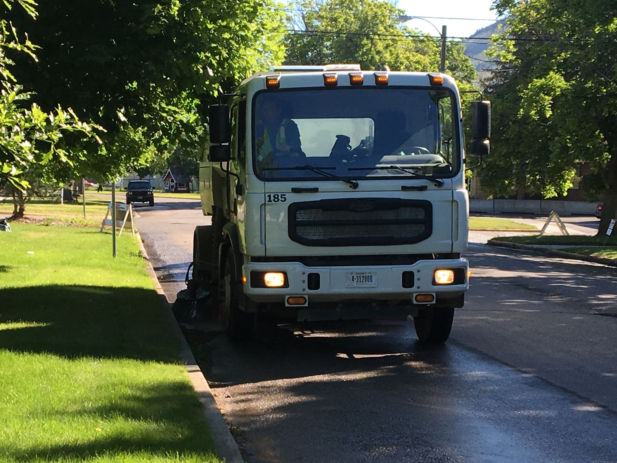 Street Sweeper sweeping curb of city street